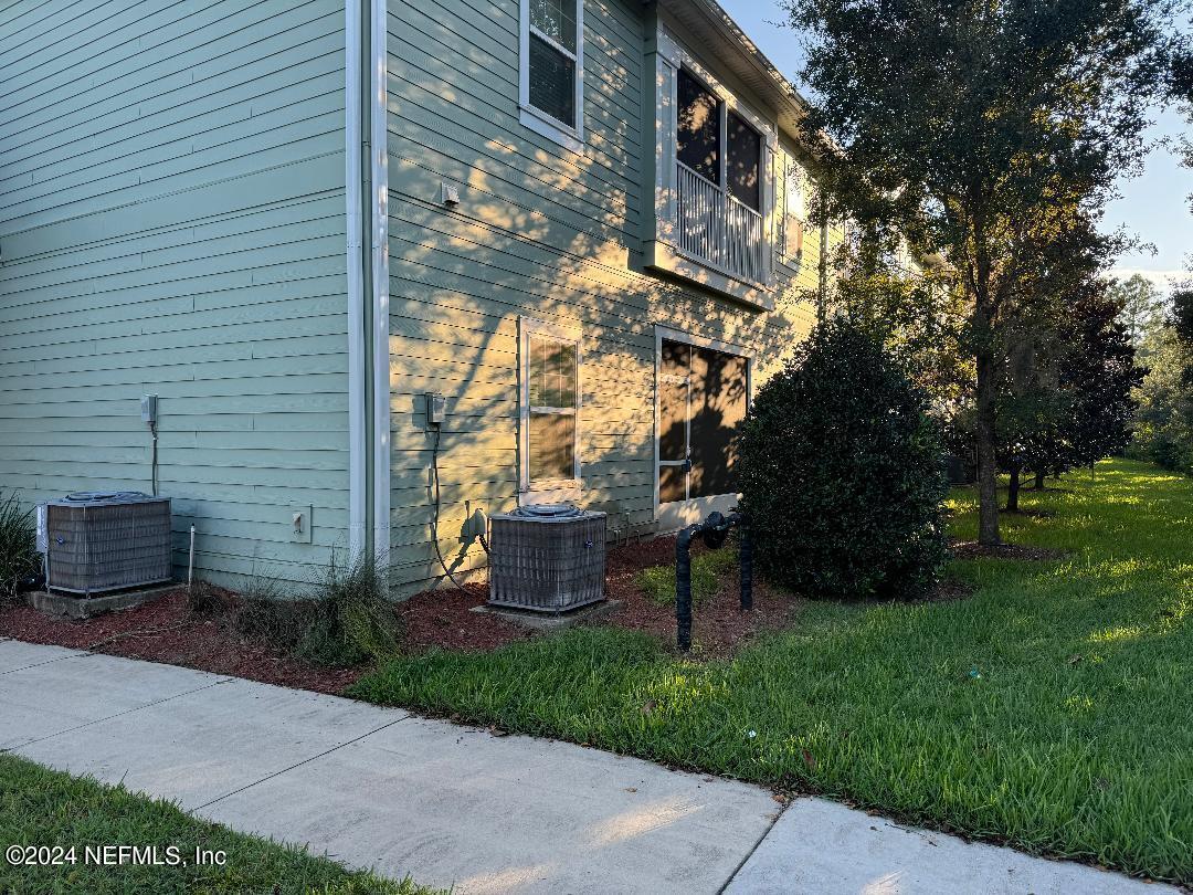 200 Larkin Place, Unit 101 St. Johns, FL 32259 - Photo 23 of 29 a view of a patio with table and chairs and potted plants