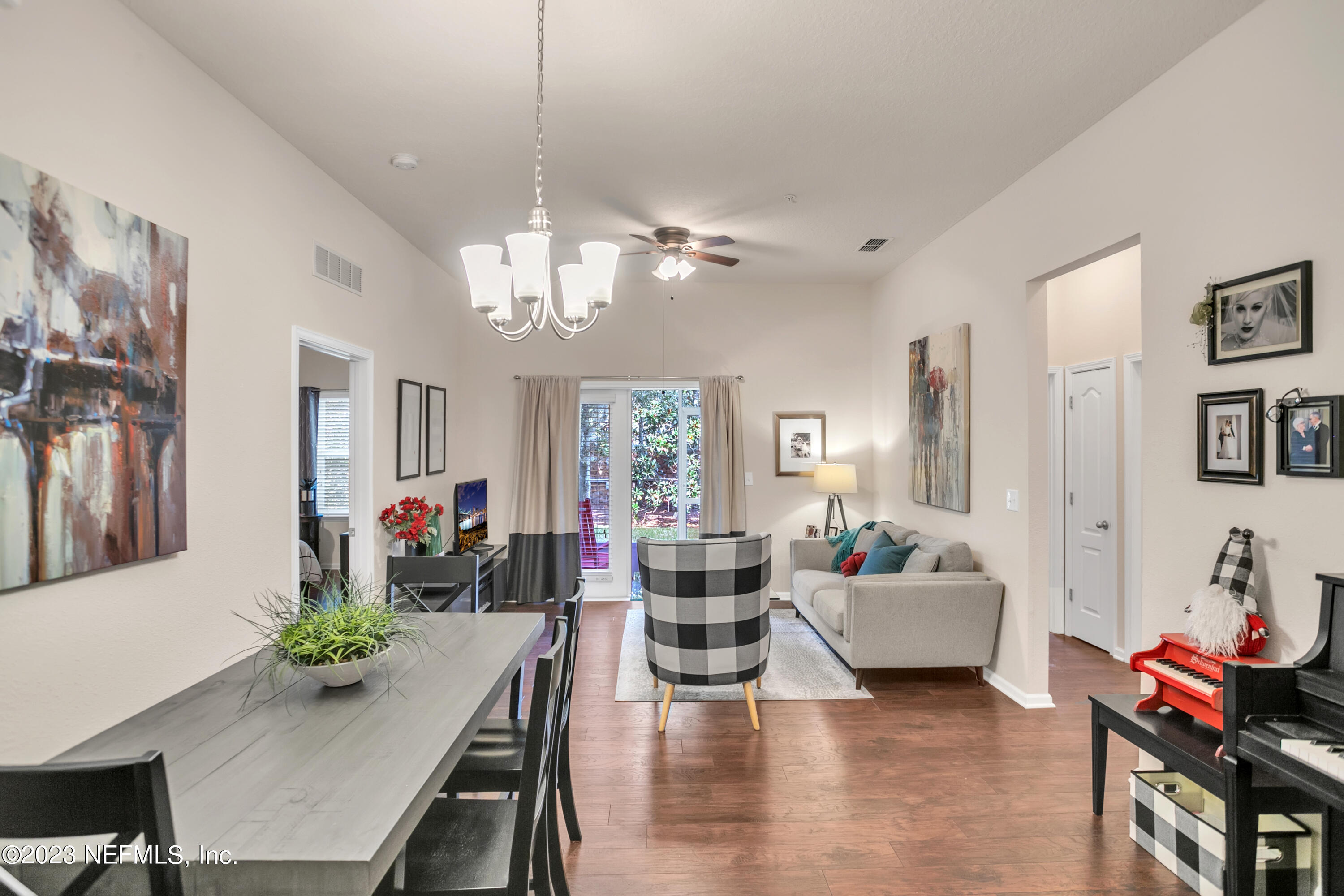 200 Larkin Place, Unit 101 St. Johns, FL 32259 - Photo 4 of 29 a living room with fireplace furniture and a chandelier