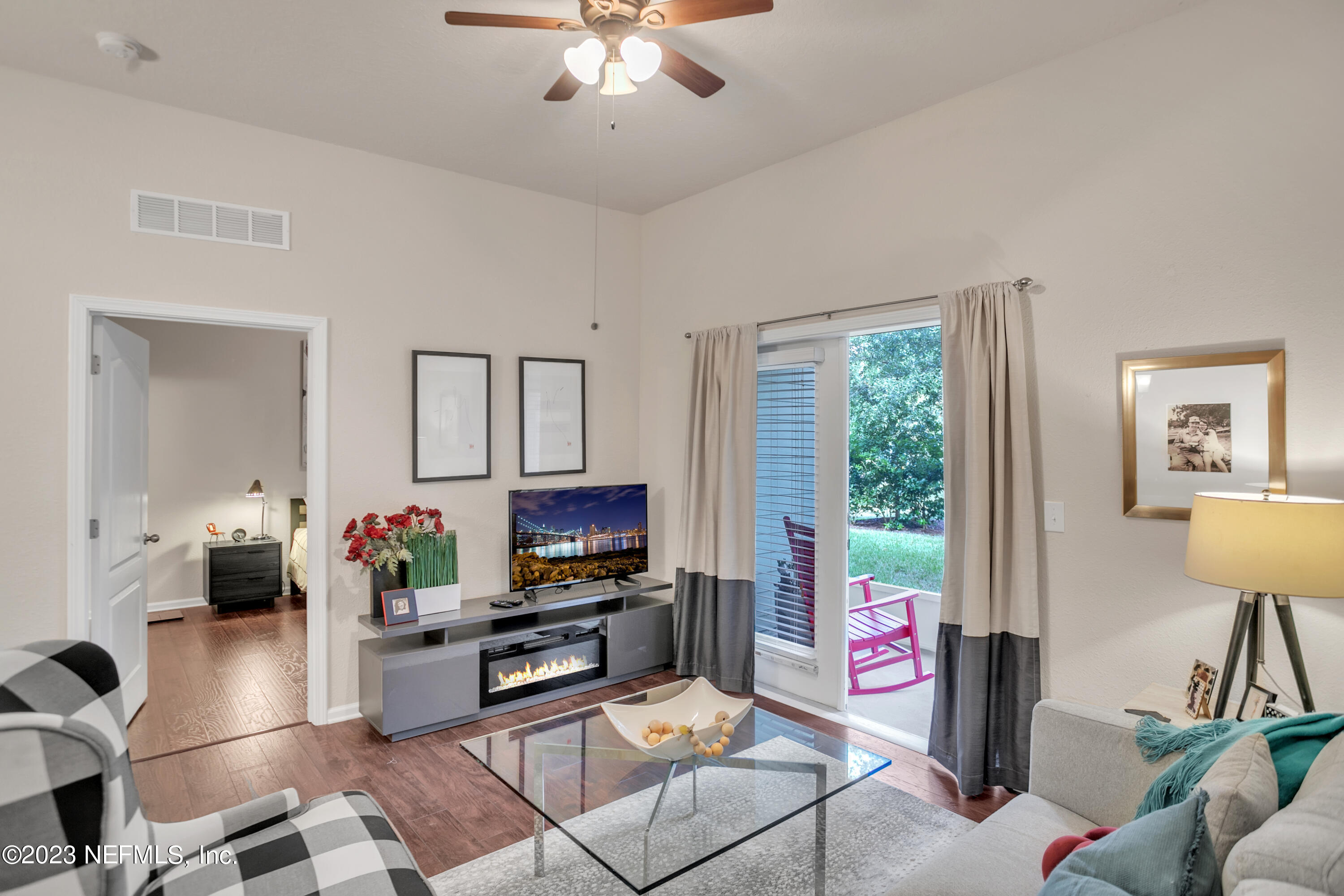 200 Larkin Place, Unit 101 St. Johns, FL 32259 - Photo 6 of 29 a living room with furniture a flat screen tv and a window