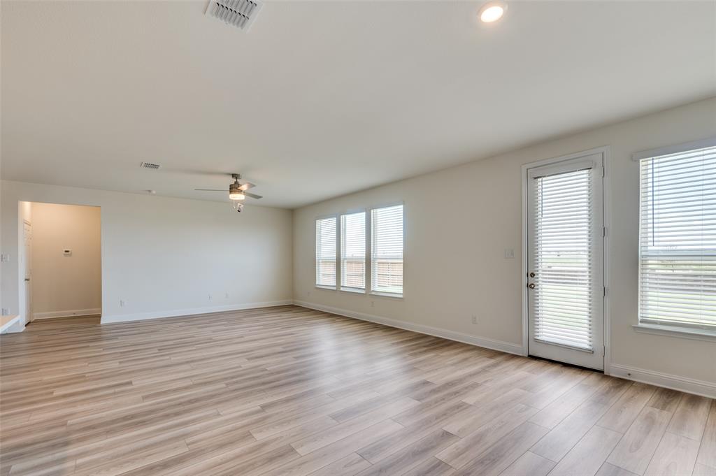 341 Fallbrook Drive Aledo, TX 76008 - Photo 6 of 40 Empty room featuring a ceiling fan and light wood-style flooring