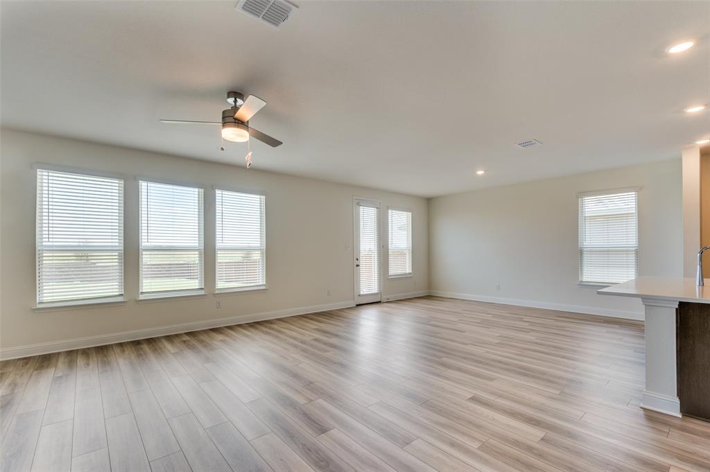 341 Fallbrook Drive Aledo, TX 76008 - Photo 7 of 40 Unfurnished living room featuring a ceiling fan, light wood-type flooring, healthy amount of natural light, and recessed lighting