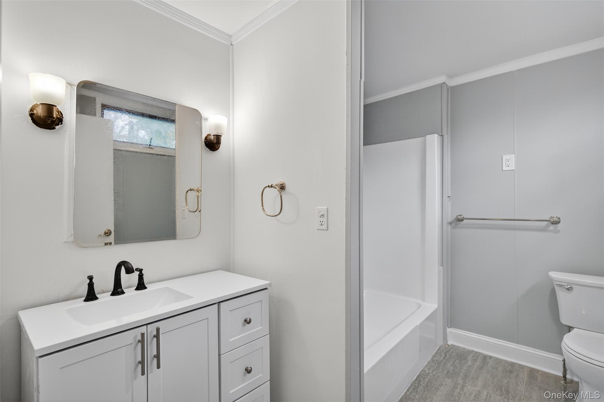 95 Market Street Wappingers Falls, NY 12590 - Photo 2 of 15 a bathroom with a sink a toilet a mirror and shower