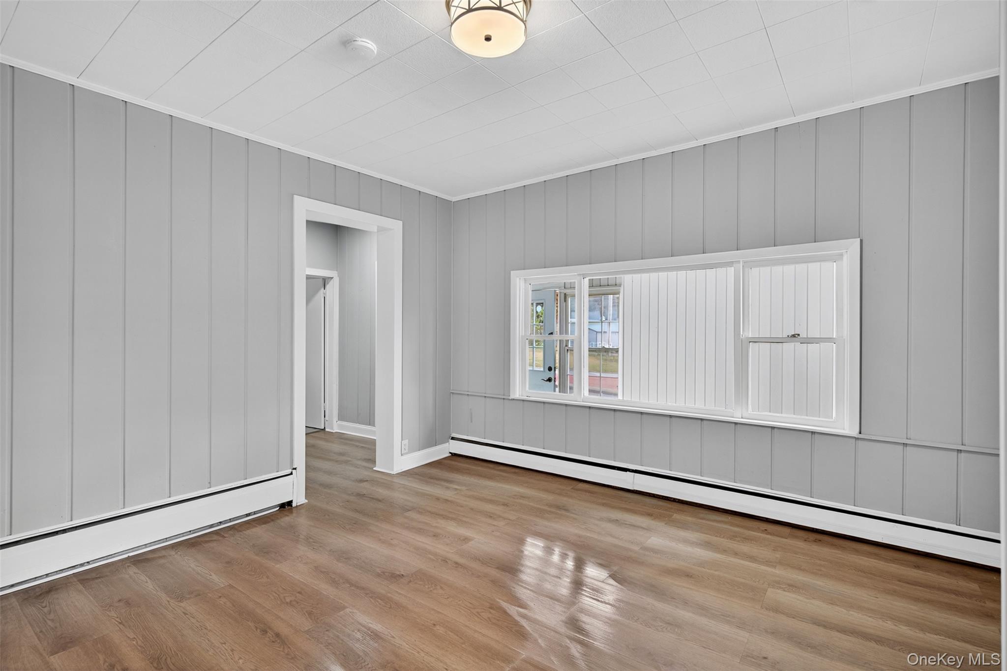 95 Market Street Wappingers Falls, NY 12590 - Photo 5 of 15 an empty room with wooden floor and windows