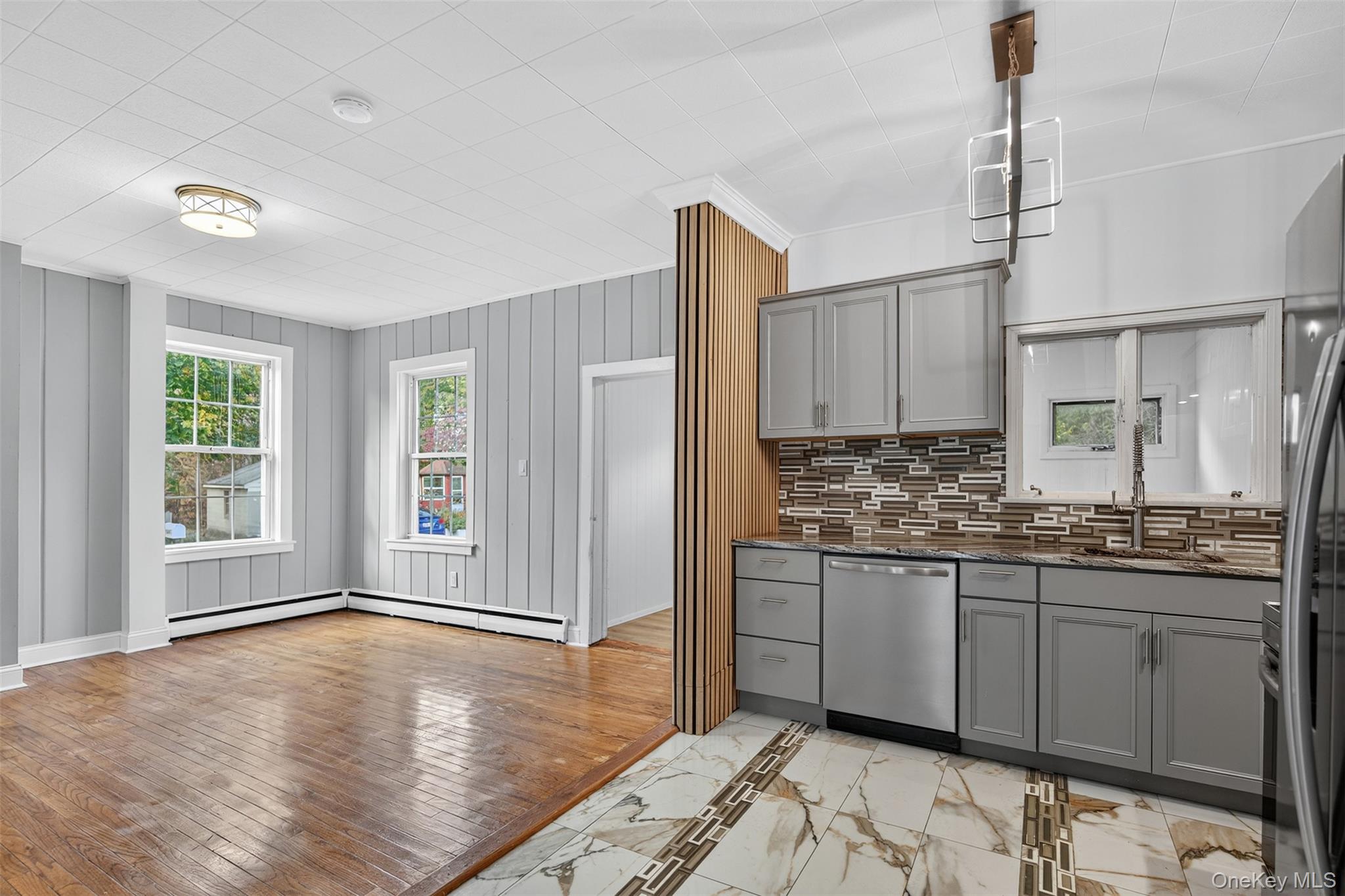95 Market Street Wappingers Falls, NY 12590 - Photo 8 of 15 a kitchen with stainless steel appliances granite countertop a stove a sink and white cabinets with wooden floor