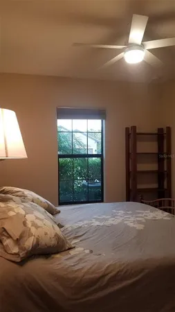a bedroom with a bed and a window