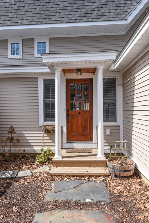 32 North Prospect Street, Unit 4 Amherst, MA 01002 - Photo 27 of 29 a front view of a house with a chair and glass door