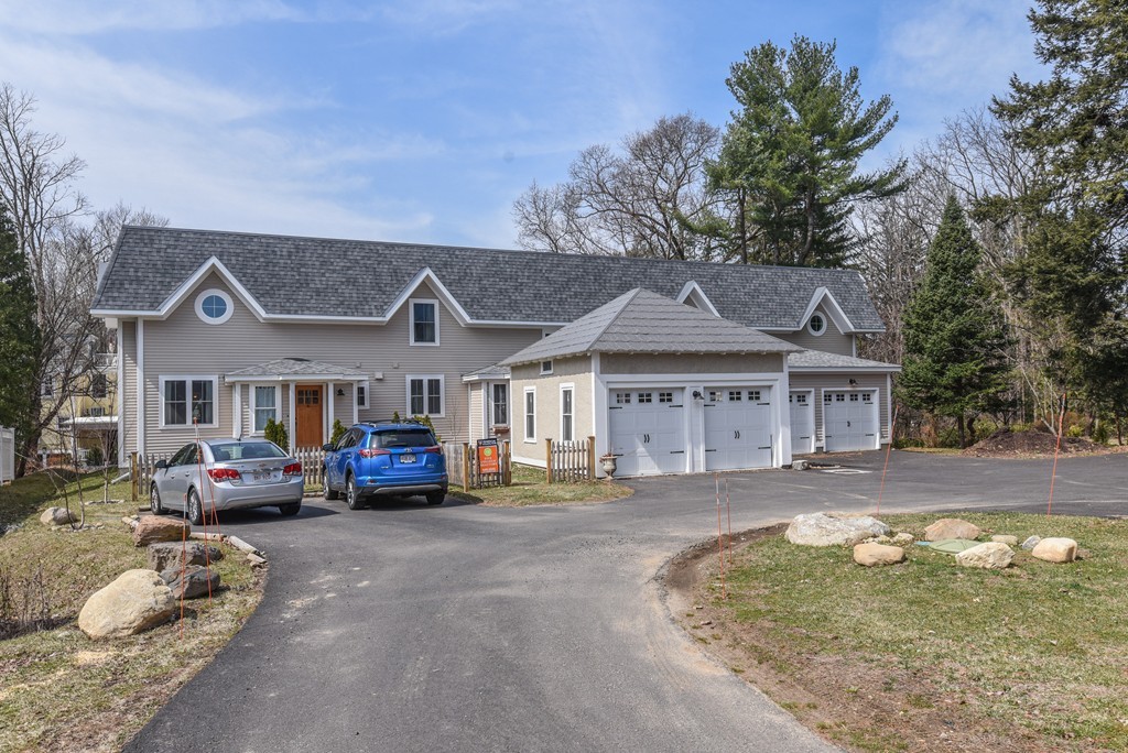 32 North Prospect Street, Unit 4 Amherst, MA 01002 - Photo 29 of 29 a front view of a house with a garden and parking space