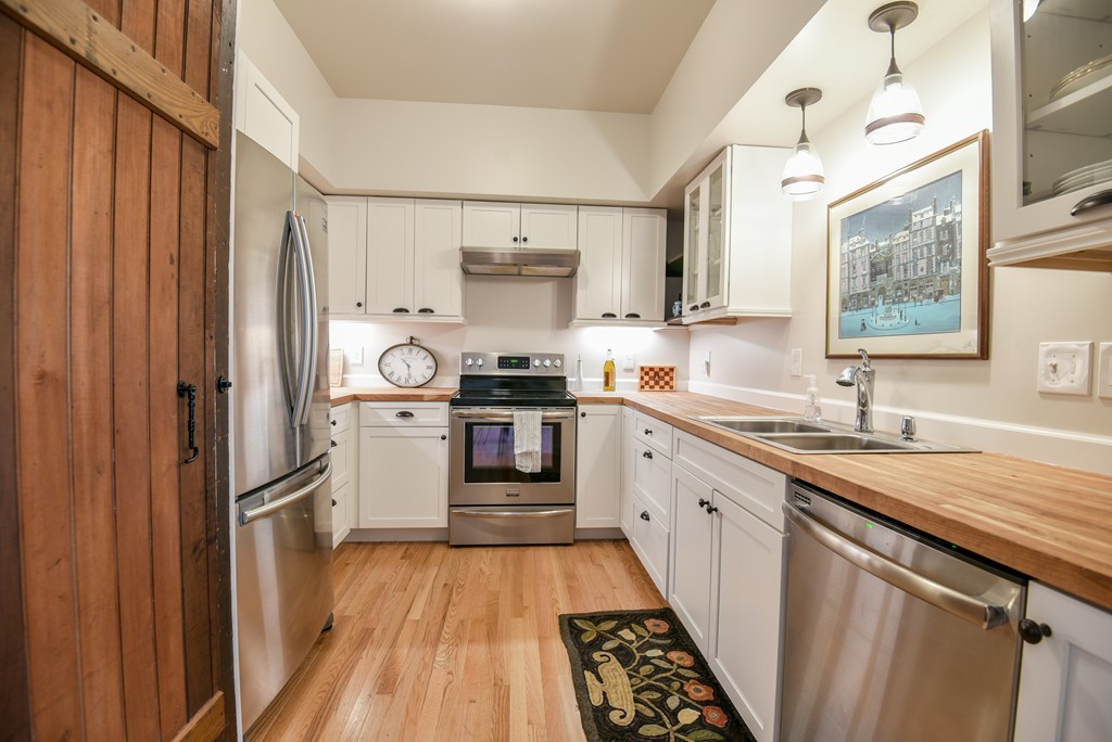 32 North Prospect Street, Unit 4 Amherst, MA 01002 - Photo 7 of 29 a kitchen with white cabinets and appliances