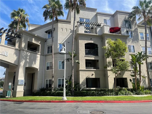 a front view of multiple houses with yard