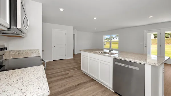 a kitchen with a stove microwave and sink