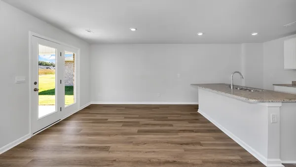 a view of kitchen with wooden floor and electronic appliances