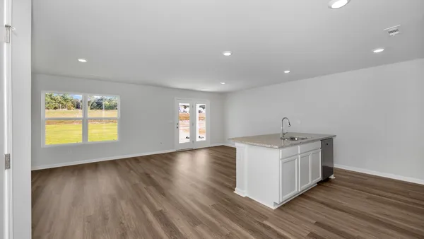 a kitchen with a sink a microwave a stove and refrigerator