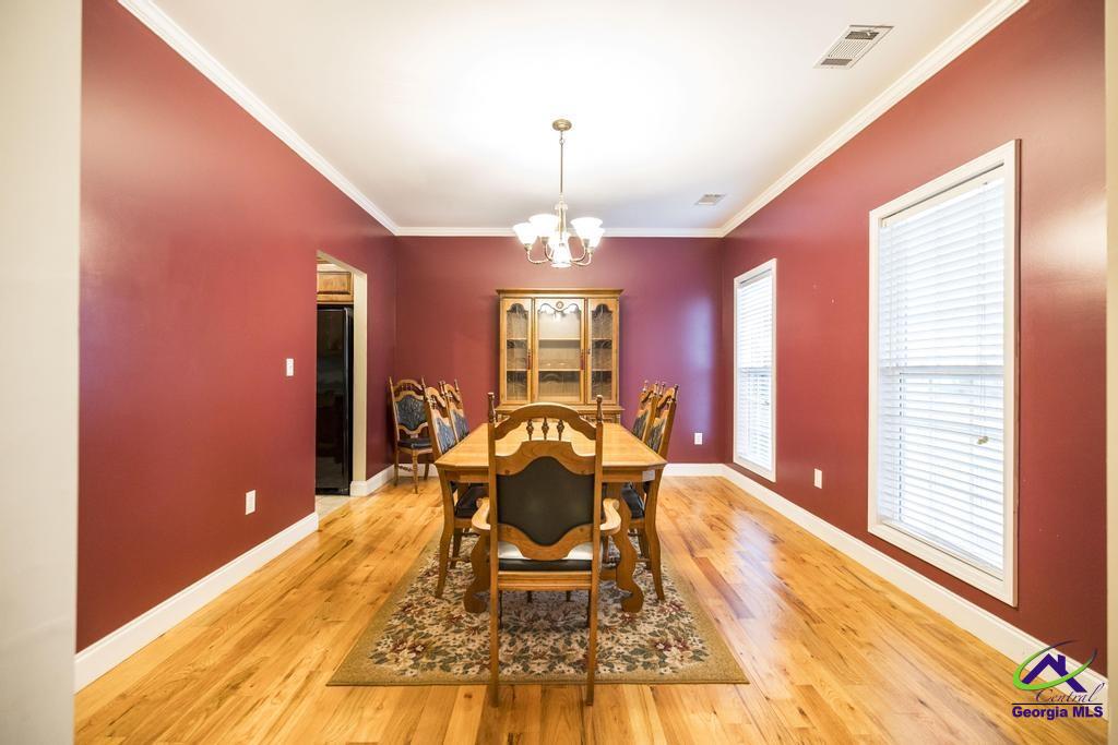 204 Smith Road Haddock, GA 31033 - Photo 7 of 51 a living room with furniture a chandelier and a large window