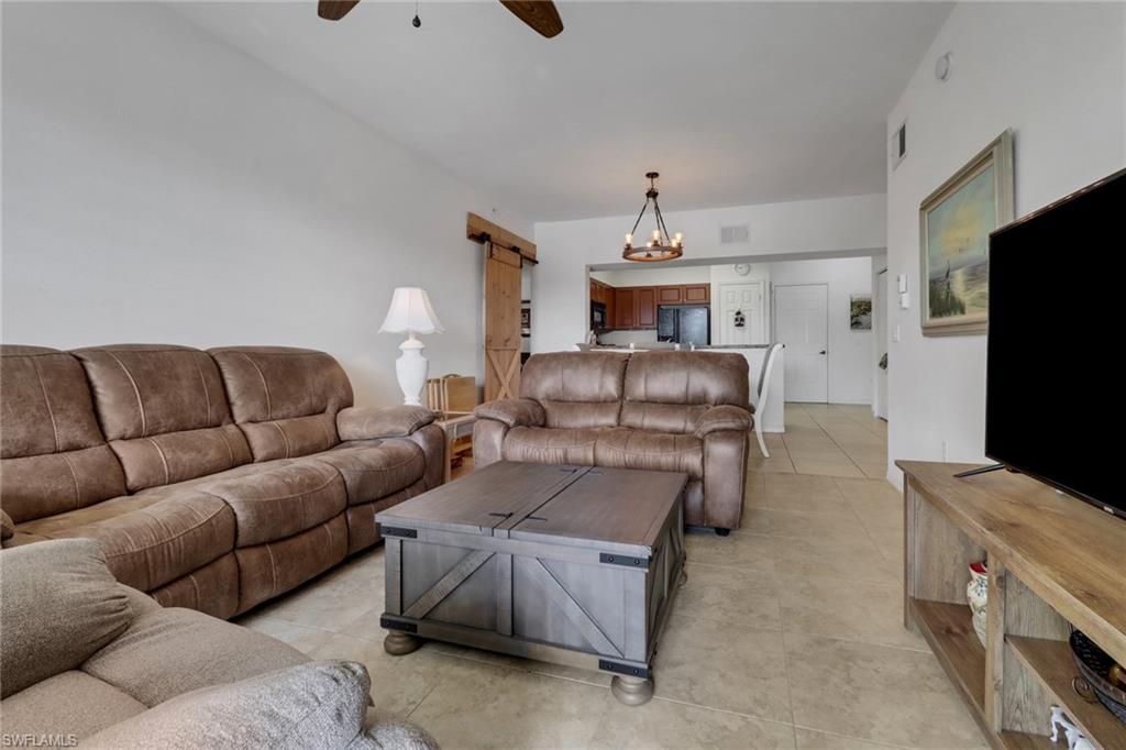 20230 Estero Gardens Circle, Unit 105 Estero, FL 33928 - Photo 11 of 44 a living room with furniture and a flat screen tv