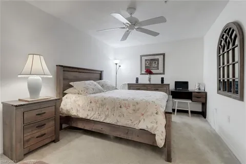 a bedroom with a bed and a night stand