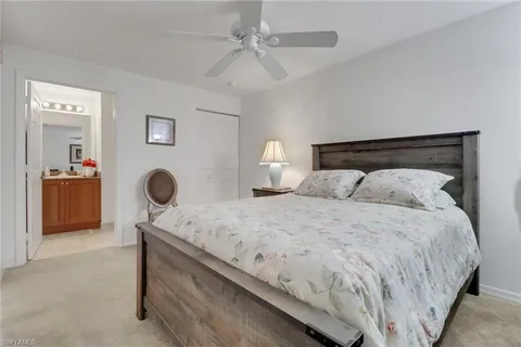 a bedroom with a bed and cabinets