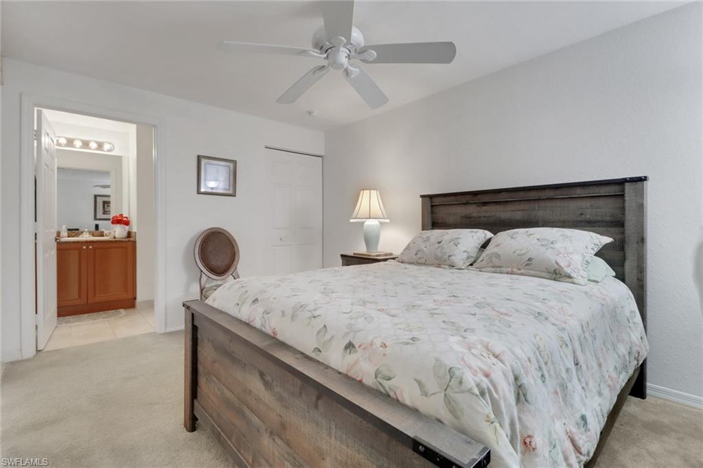 20230 Estero Gardens Circle, Unit 105 Estero, FL 33928 - Photo 14 of 44 a bedroom with a bed and cabinets