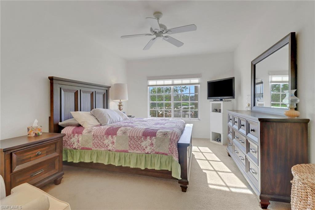 20230 Estero Gardens Circle, Unit 105 Estero, FL 33928 - Photo 16 of 44 a bedroom with a bed and a flat screen tv