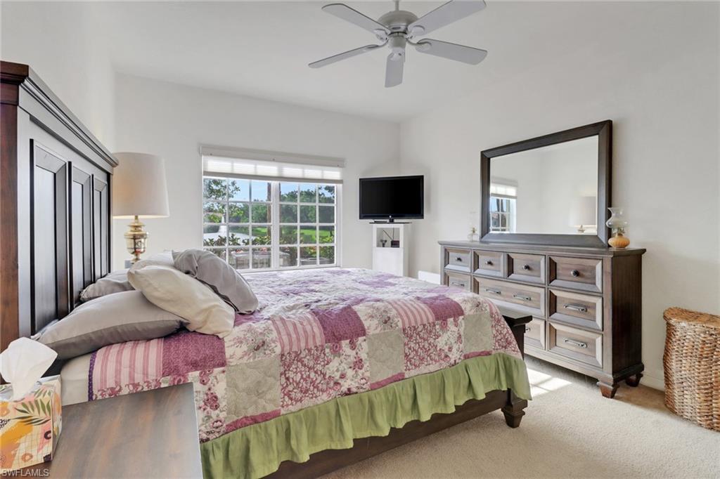 20230 Estero Gardens Circle, Unit 105 Estero, FL 33928 - Photo 17 of 44 a bedroom with a bed and a flat screen tv