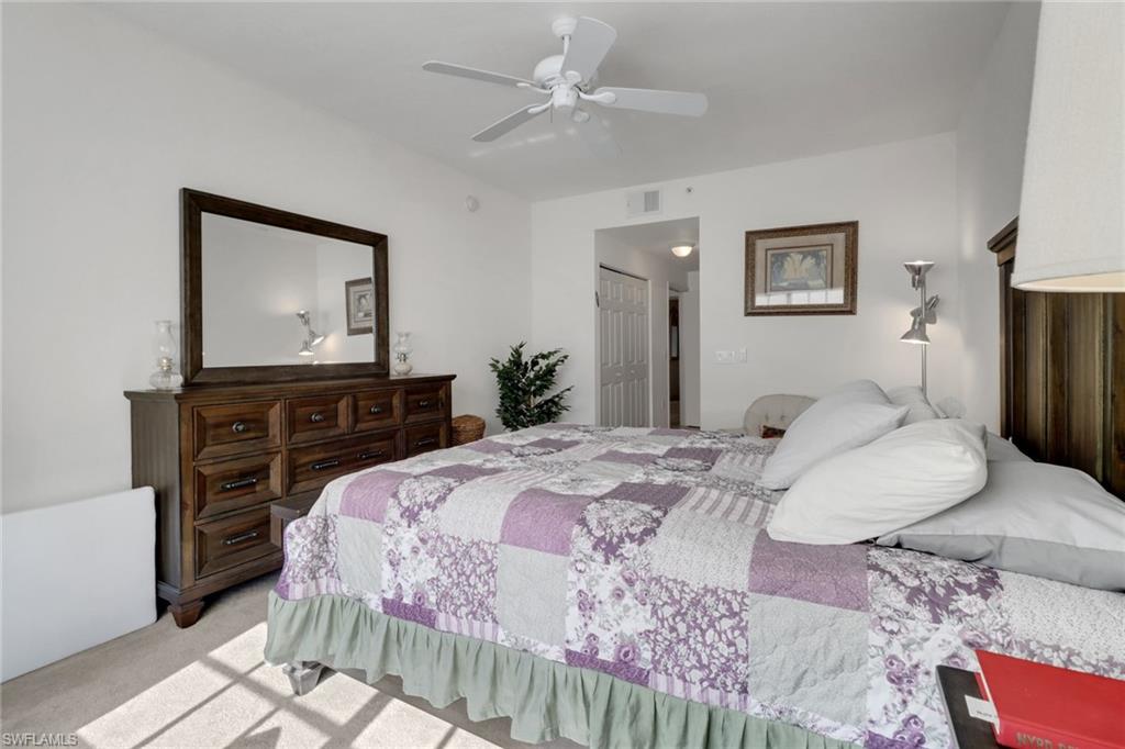 20230 Estero Gardens Circle, Unit 105 Estero, FL 33928 - Photo 18 of 44 a bedroom with a bed and a dresser