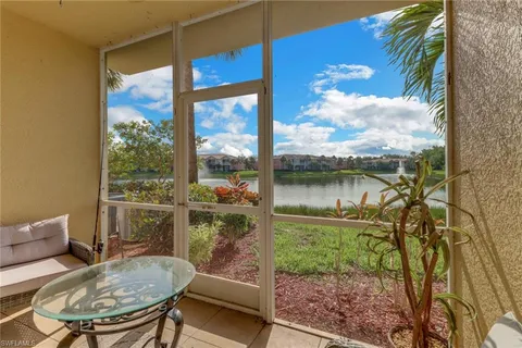 a balcony with table and chairs