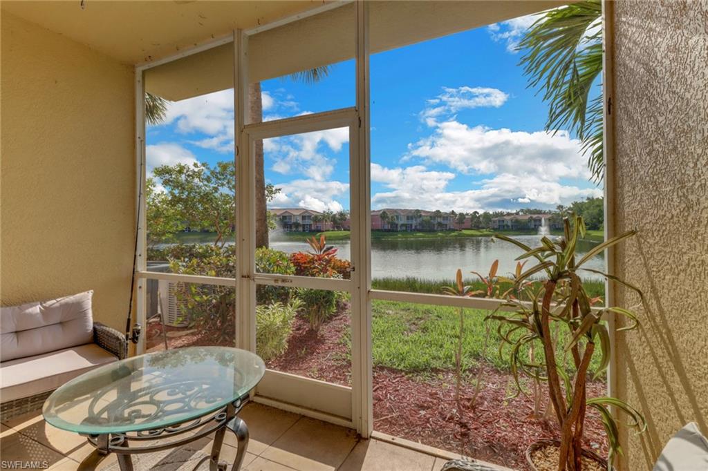 20230 Estero Gardens Circle, Unit 105 Estero, FL 33928 - Photo 24 of 44 a balcony with table and chairs
