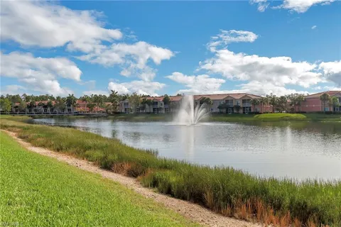 a view of a lake with houses in the back