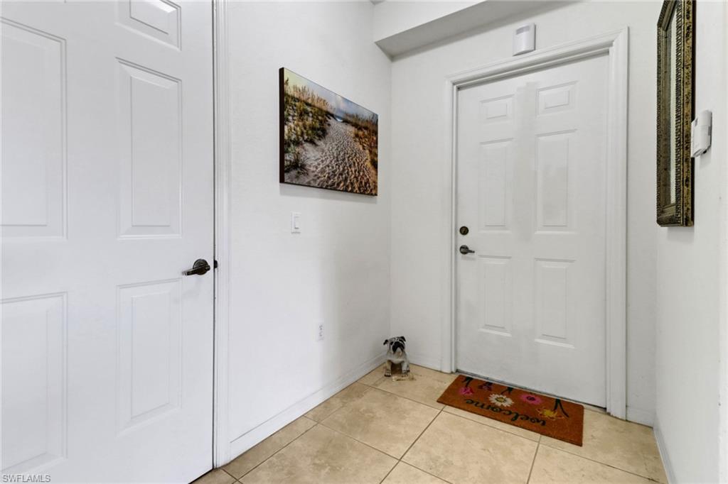 20230 Estero Gardens Circle, Unit 105 Estero, FL 33928 - Photo 3 of 44 a view of a hallway with wooden floor and closet