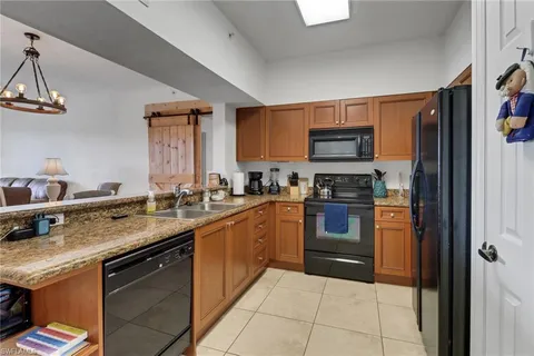 a kitchen with stainless steel appliances granite countertop a stove sink and cabinets