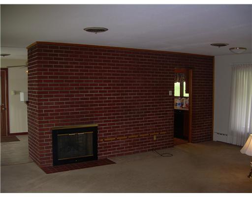 Living Room. Gas Log Fireplace on Both Sides of Brick Wall