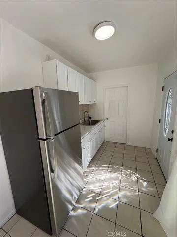 a kitchen with a refrigerator and a sink