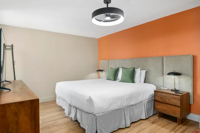 a bedroom with a bed and a chandelier