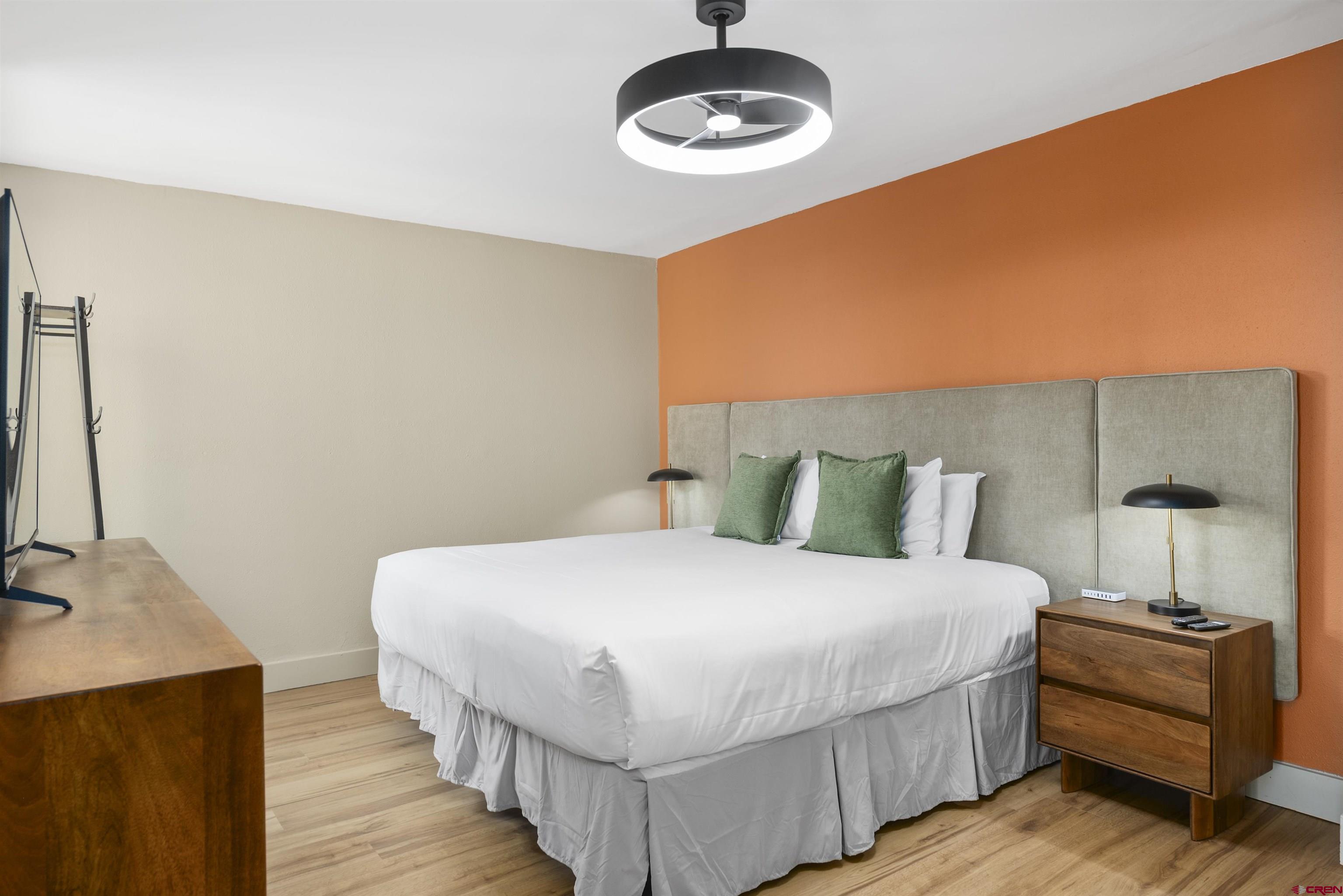 6 Emmons Road, Unit 351 Crested Butte, CO 81225 - Photo 14 of 21 a bedroom with a bed and a chandelier