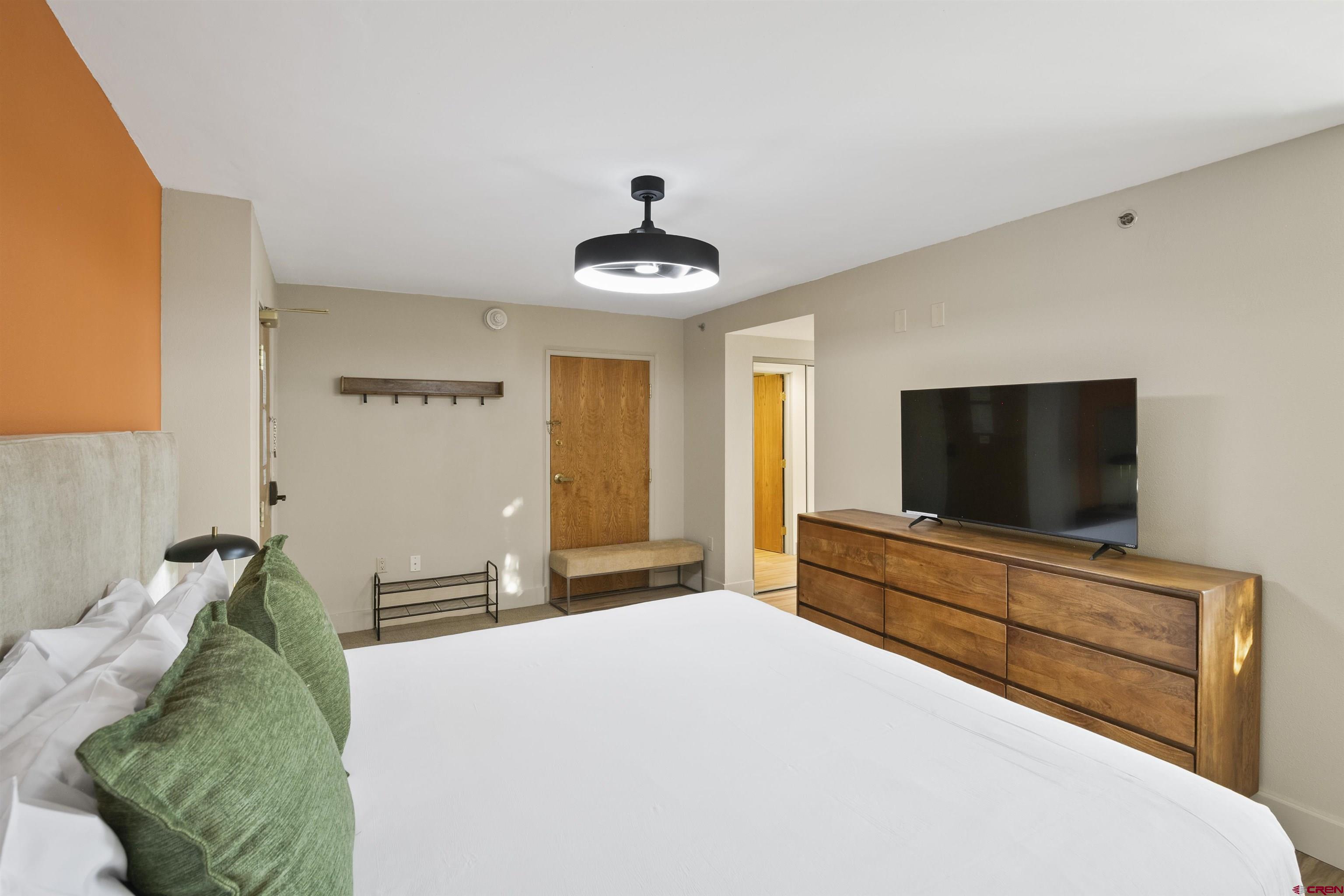 6 Emmons Road, Unit 351 Crested Butte, CO 81225 - Photo 16 of 21 a bedroom with a bed and a flat screen tv