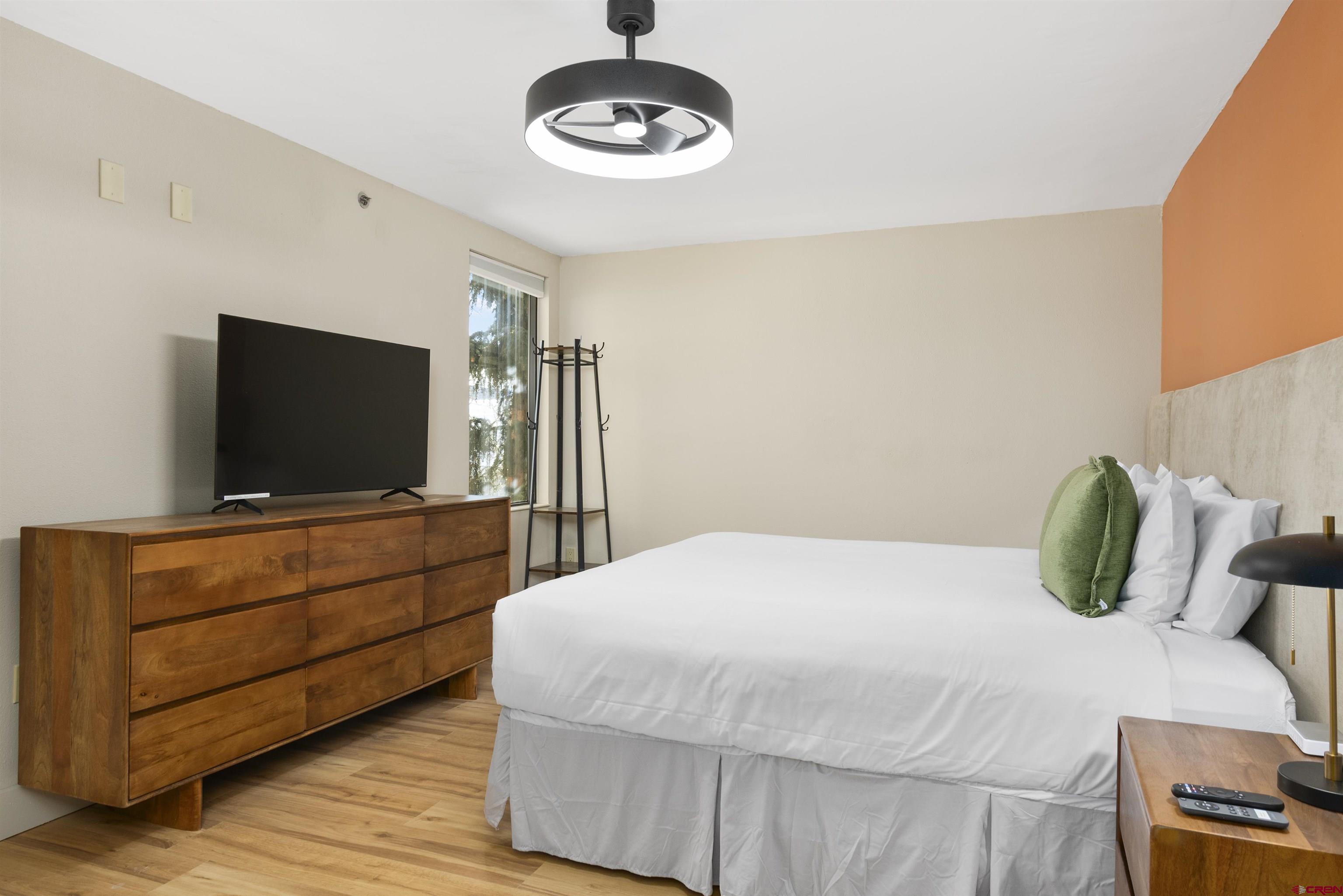 6 Emmons Road, Unit 351 Crested Butte, CO 81225 - Photo 2 of 21 a bedroom with a bed and a flat screen tv