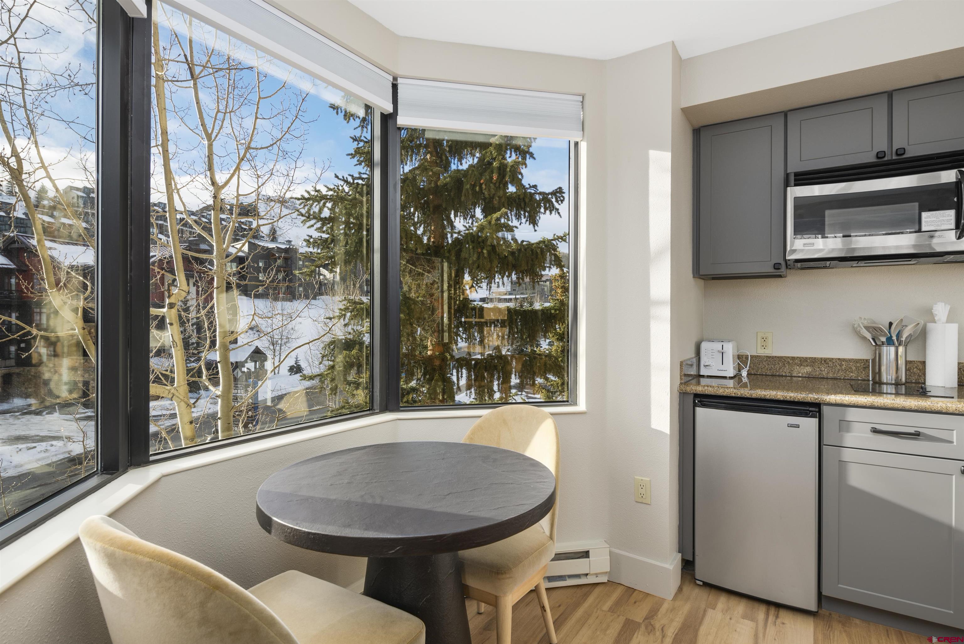 6 Emmons Road, Unit 351 Crested Butte, CO 81225 - Photo 4 of 21 a dining room with furniture and window