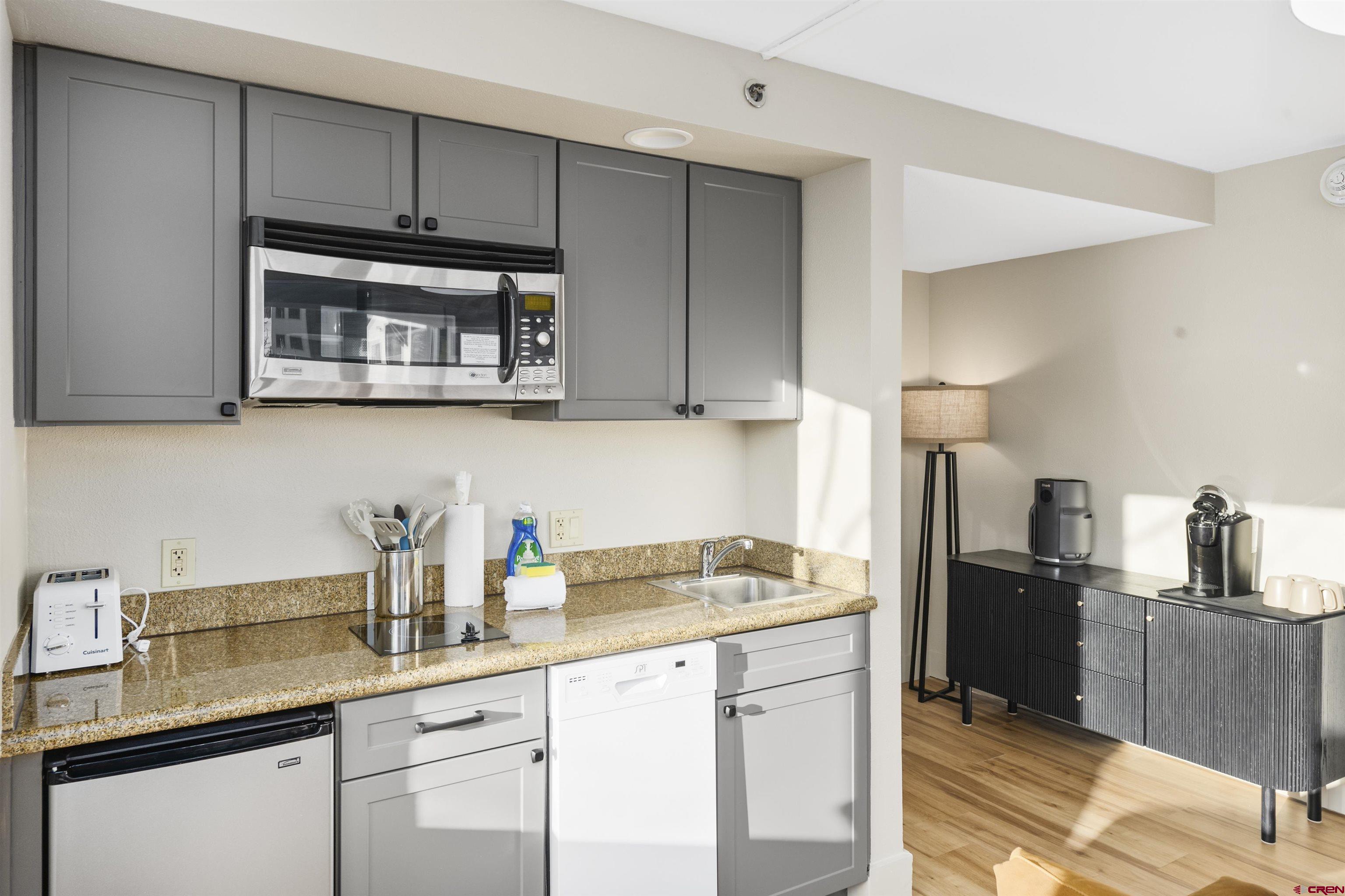 6 Emmons Road, Unit 351 Crested Butte, CO 81225 - Photo 6 of 21 a kitchen with stainless steel appliances granite countertop a sink stove and refrigerator