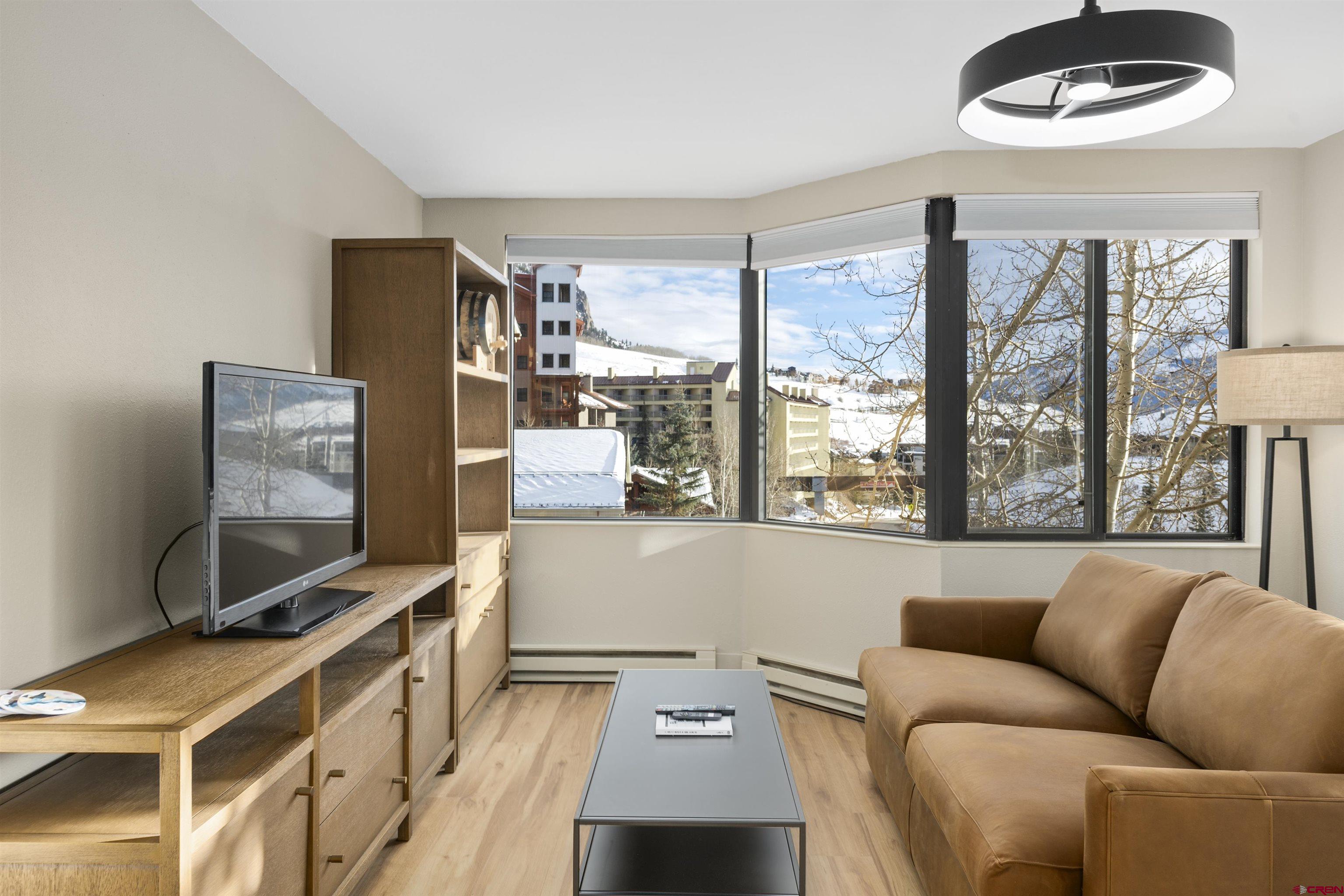 6 Emmons Road, Unit 351 Crested Butte, CO 81225 - Photo 7 of 21 a living room with furniture and a flat screen tv