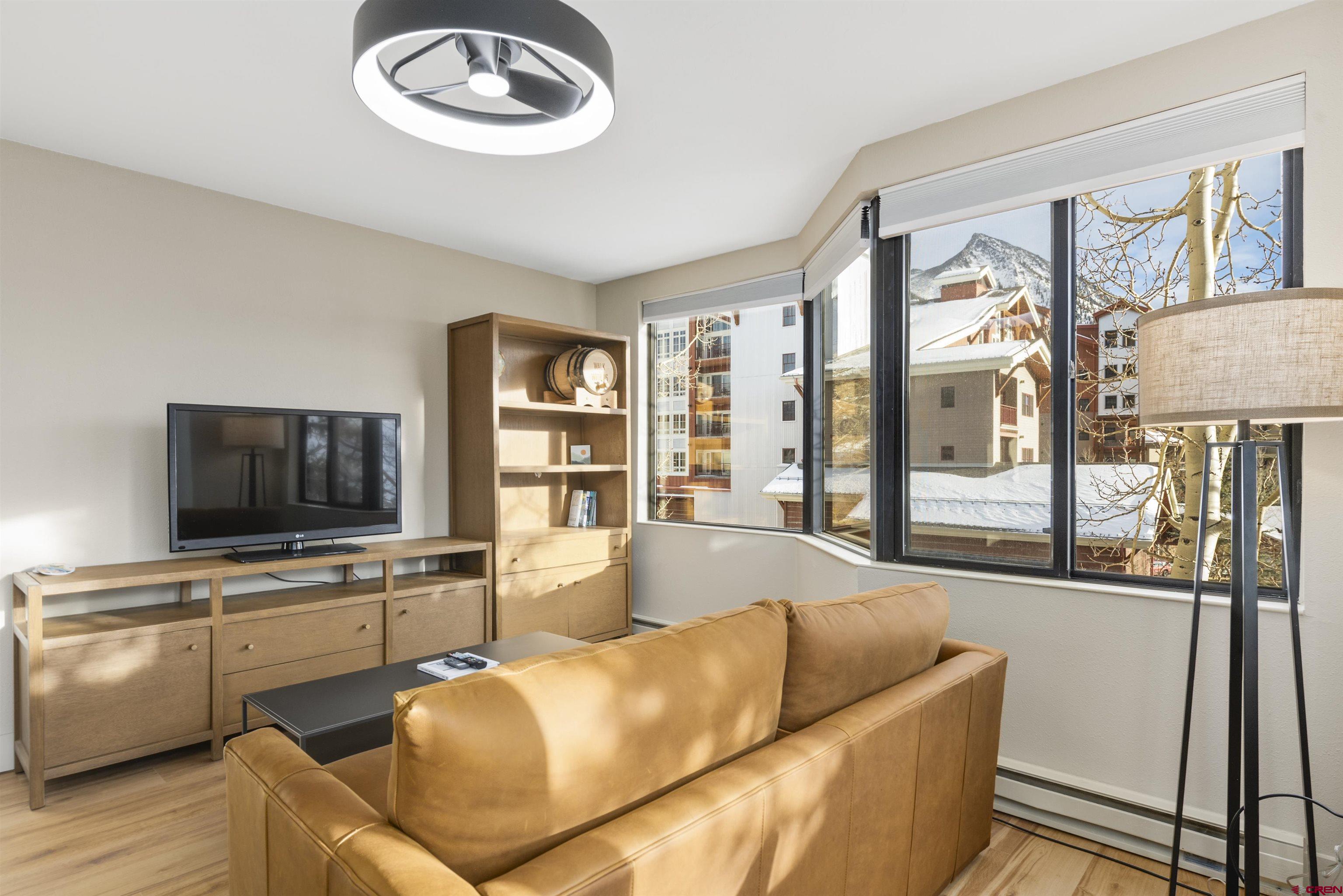 6 Emmons Road, Unit 351 Crested Butte, CO 81225 - Photo 9 of 21 a living room with furniture and a flat screen tv