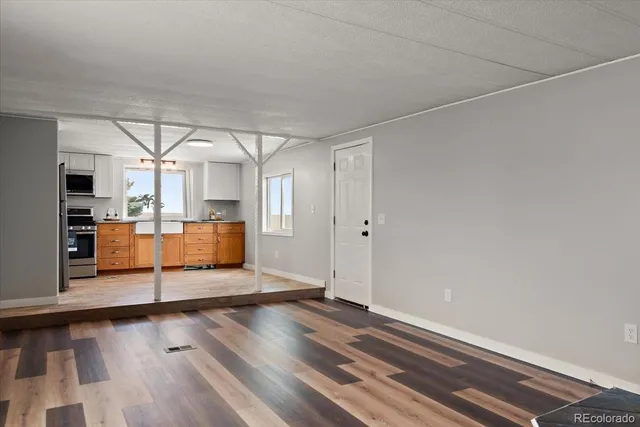 a view of a room with wooden floor and window