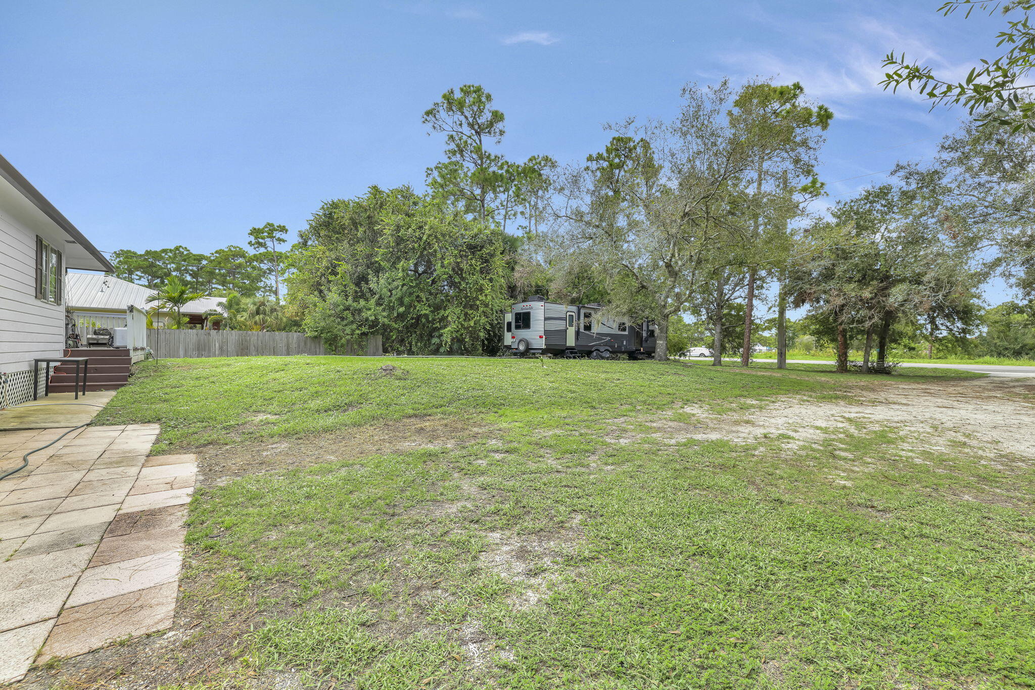 9555 Orange Avenue Fort Pierce, FL 34945 - Photo 15 of 28 a backyard of a house with lots of green space