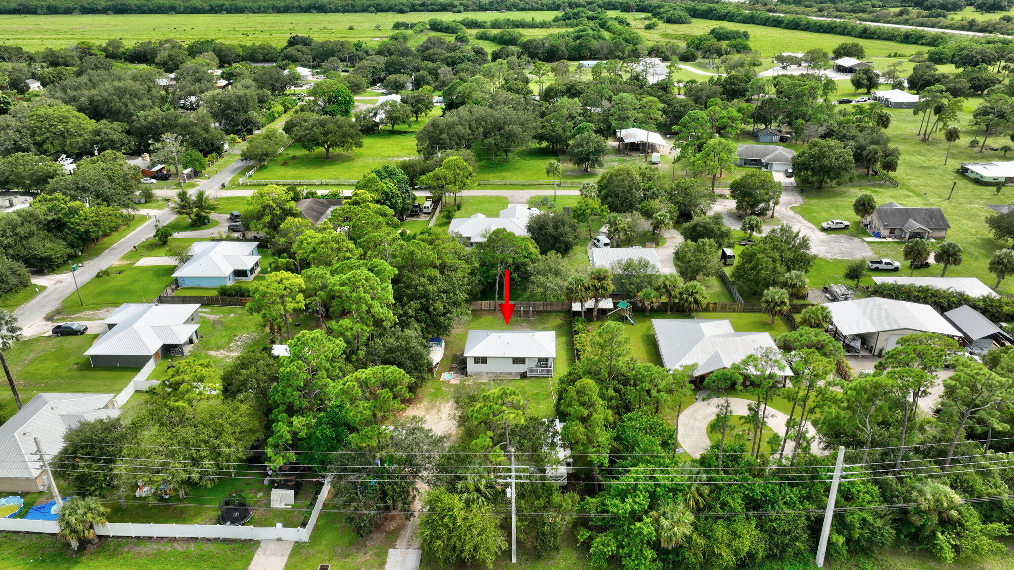 9555 Orange Avenue Fort Pierce, FL 34945 - Photo 20 of 28 an aerial view of residential houses with outdoor space and trees
