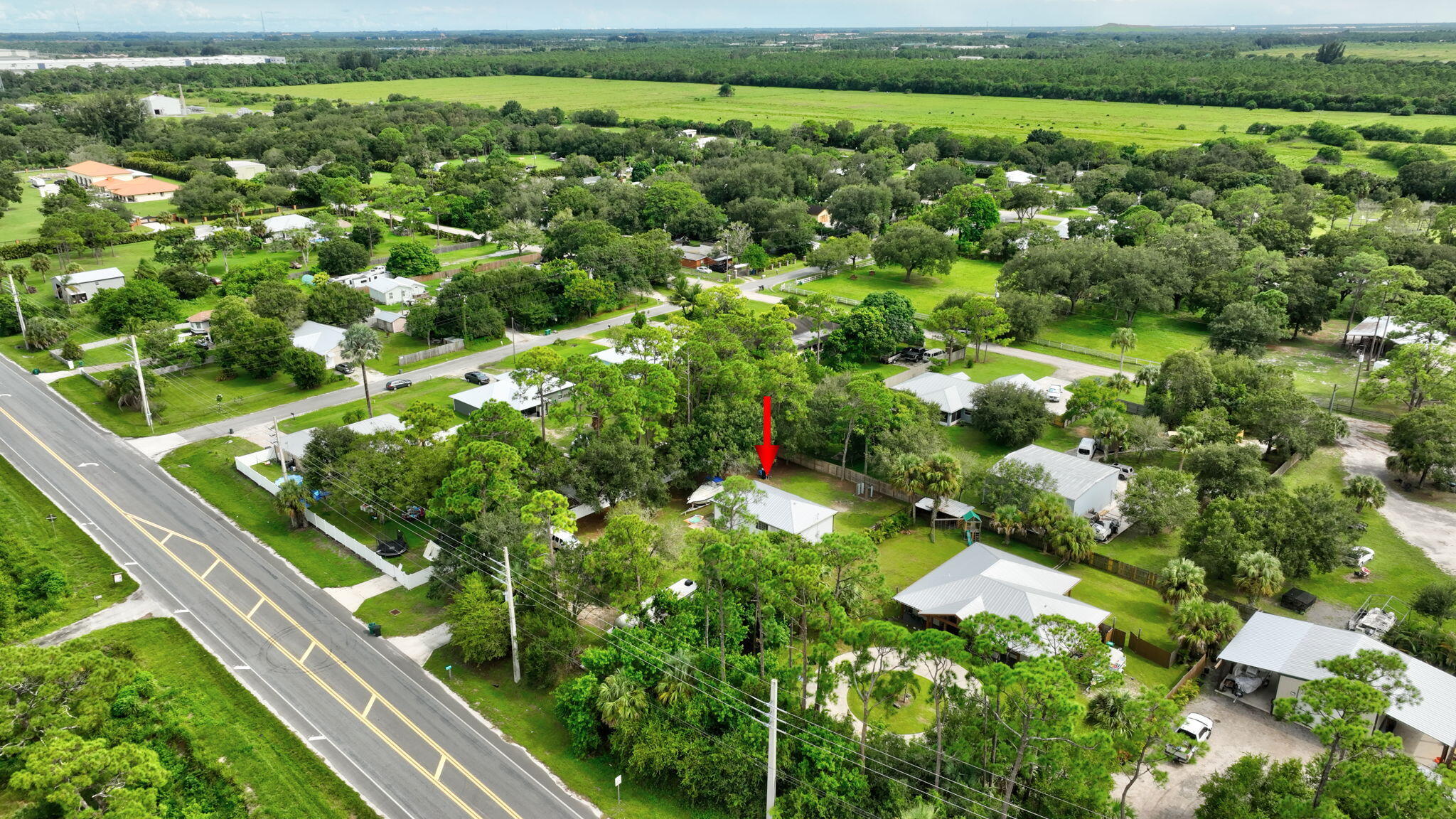 9555 Orange Avenue Fort Pierce, FL 34945 - Photo 21 of 28 a view of a field with a tree