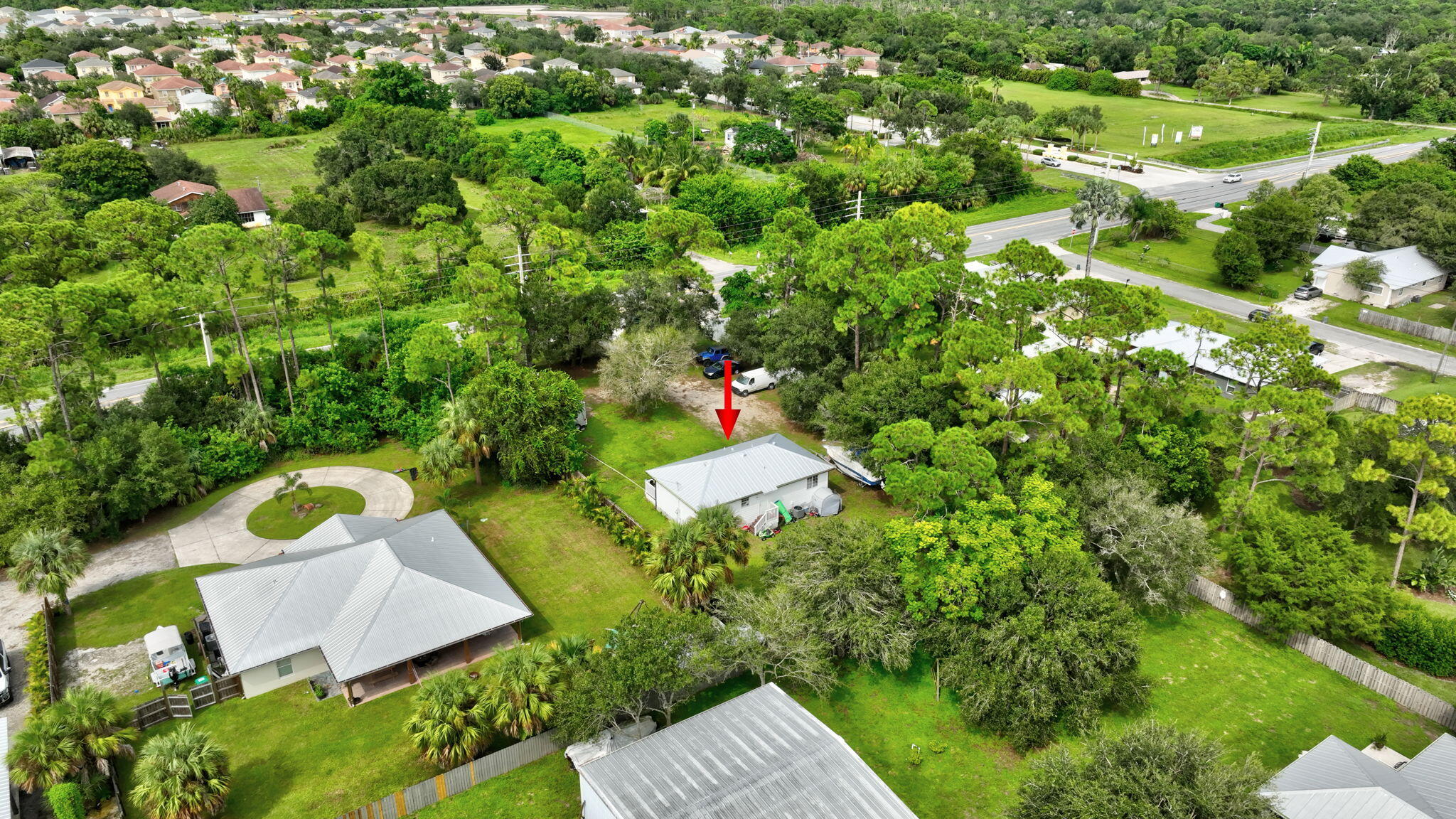 9555 Orange Avenue Fort Pierce, FL 34945 - Photo 26 of 28 an aerial view of a house with a yard and outdoor seating