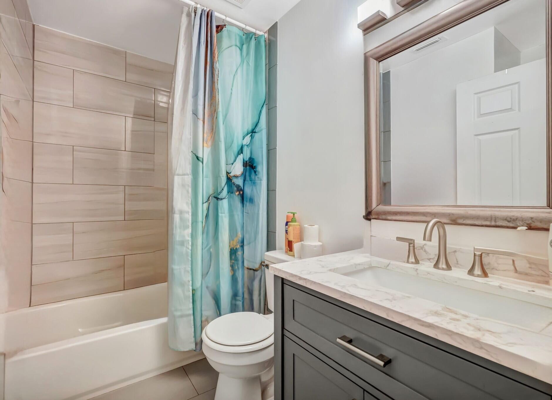 9555 Orange Avenue Fort Pierce, FL 34945 - Photo 9 of 28 a bathroom with a sink a toilet and shower