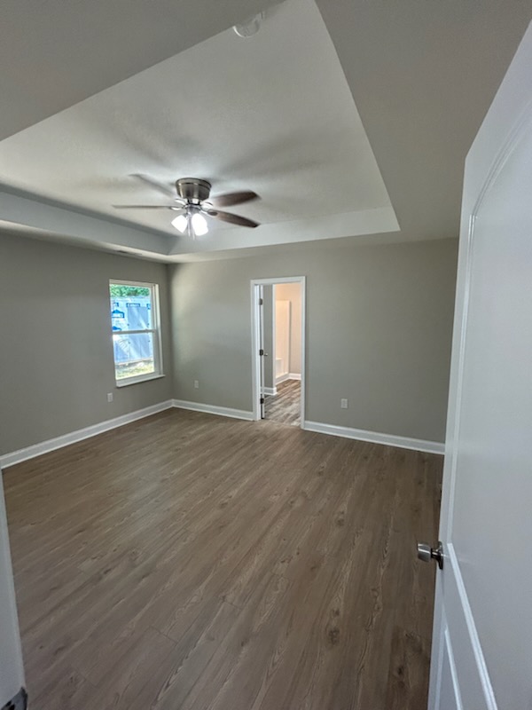 708 Hampton Street Iva, SC 29655 - Photo 7 of 14 This spacious bedroom offers comfortable living with elegant flooring and a well-designed ceiling.