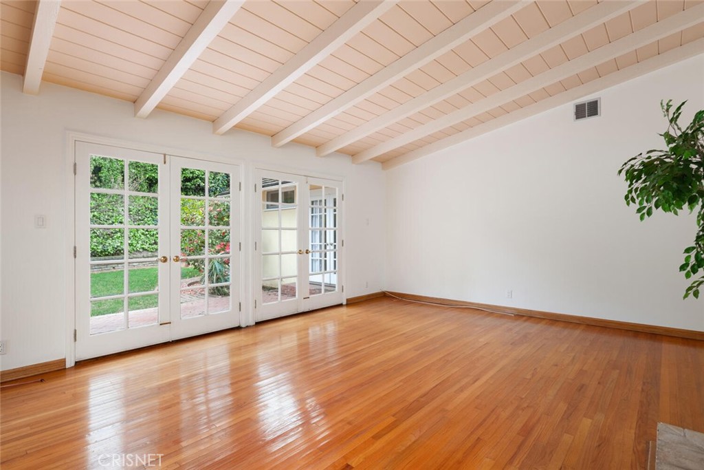 3734 Wrightwood Drive Studio City, CA 91604 - Photo 14 of 28 an empty room with wooden floor and floor to ceiling window