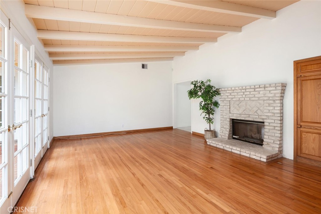 3734 Wrightwood Drive Studio City, CA 91604 - Photo 15 of 28 a view of an empty room with wooden floor fireplace and a window