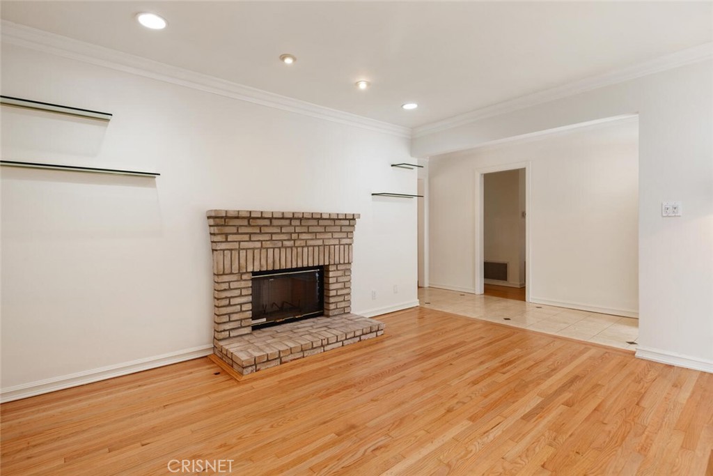 3734 Wrightwood Drive Studio City, CA 91604 - Photo 3 of 28 an empty room with wooden floor fireplace and windows