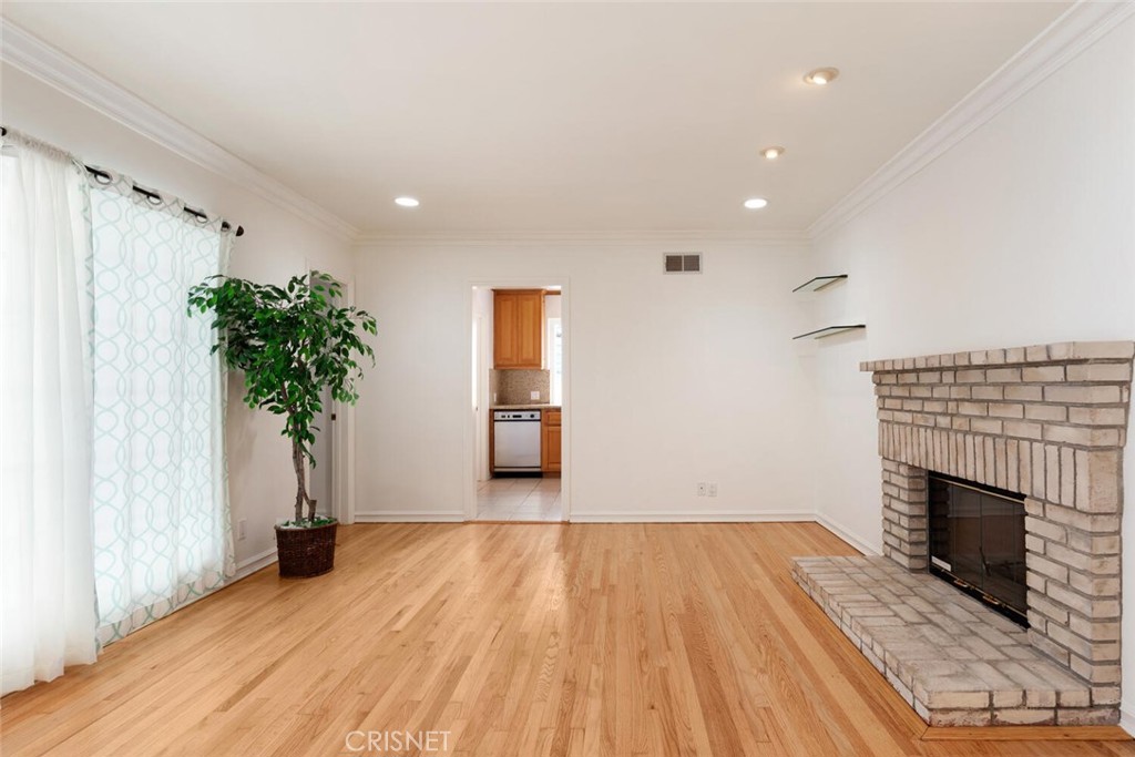 3734 Wrightwood Drive Studio City, CA 91604 - Photo 4 of 28 an empty room with wooden floor and a fireplace